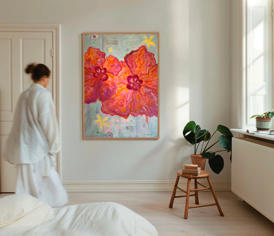 Two abstract pink hibiscus flowers painted on blue background insitu on a wall in a bedroom. 